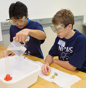Student pouring liquid into beaker
