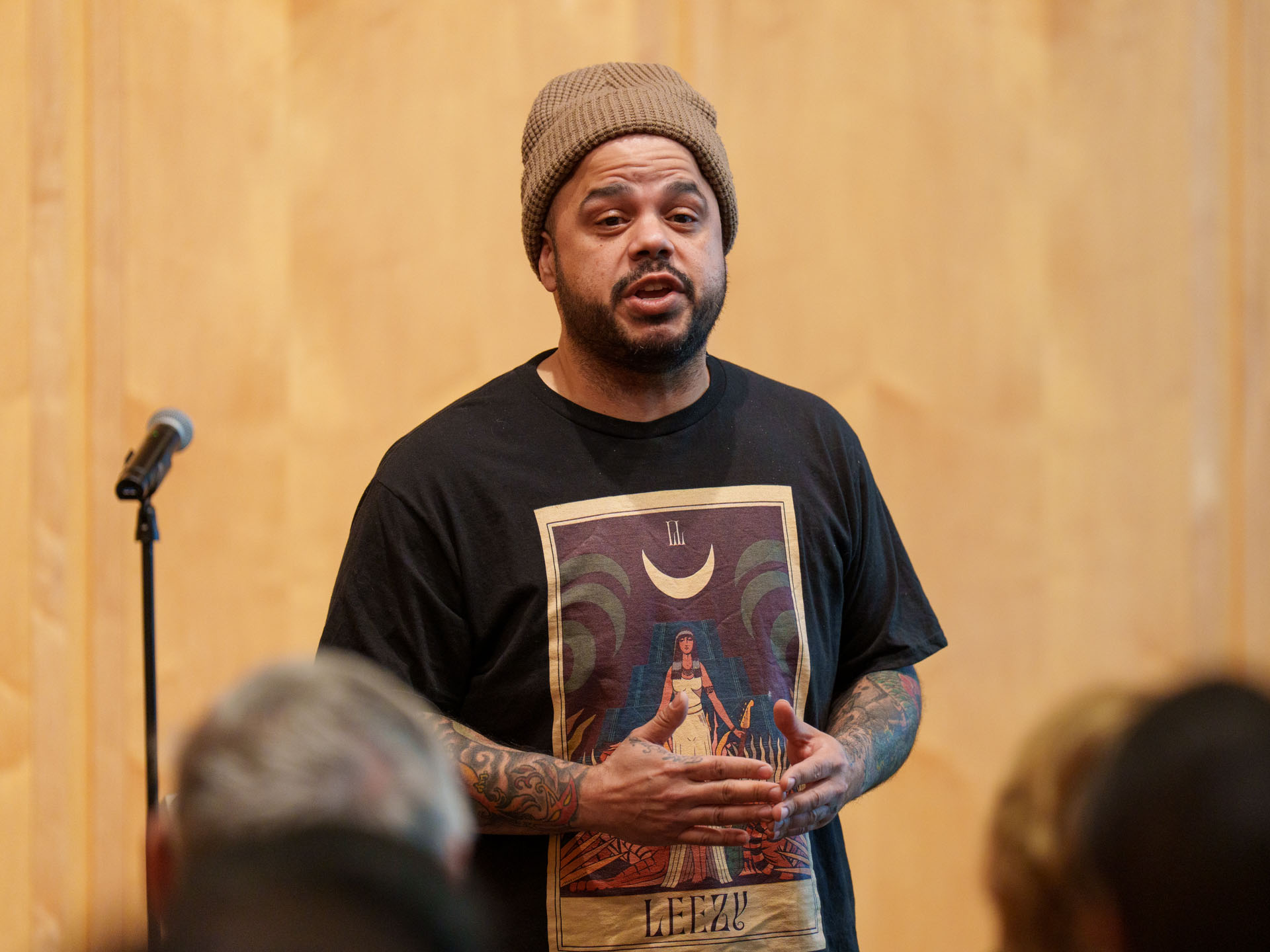 A man passionately performs spoken word in front of an audience.