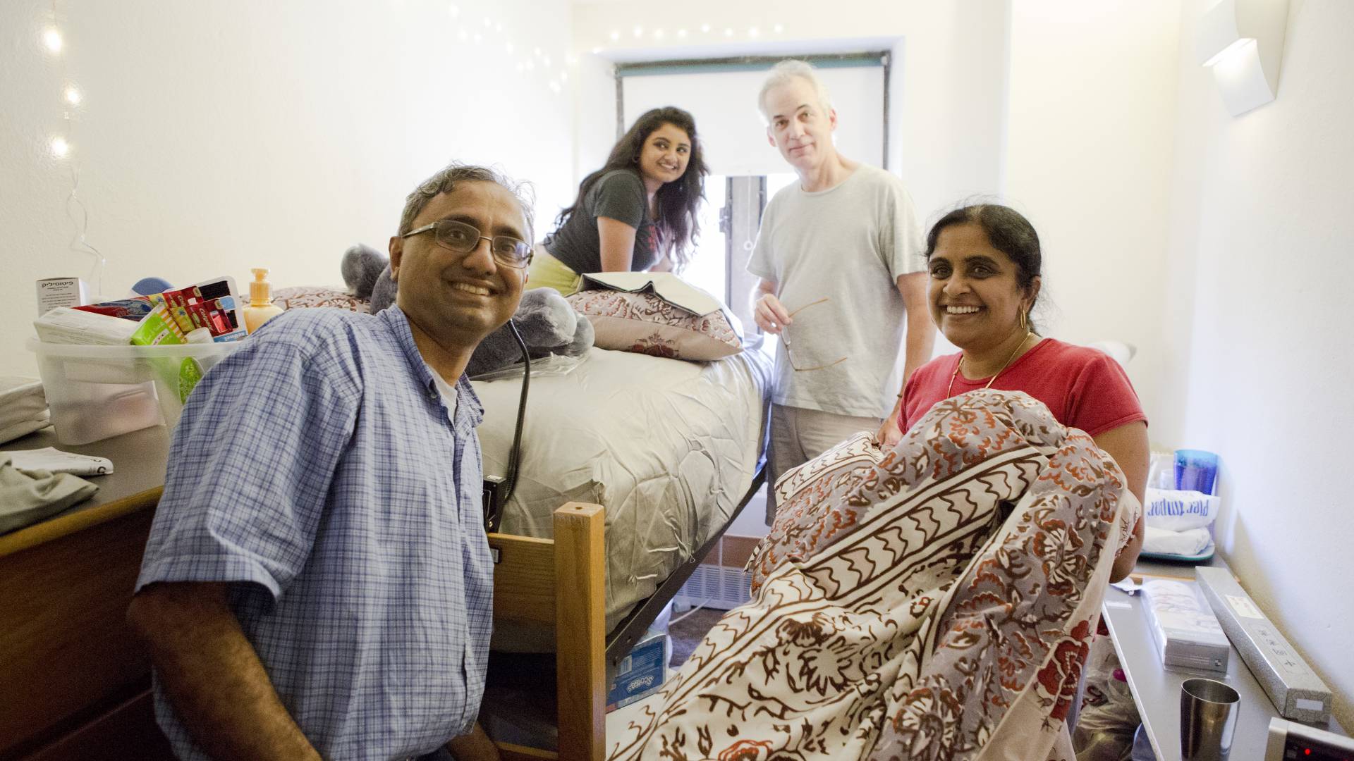Photo of students and families moving into dorm room