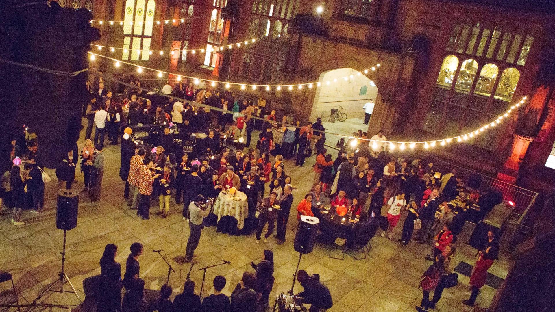 alumni gathered in courtyard at night