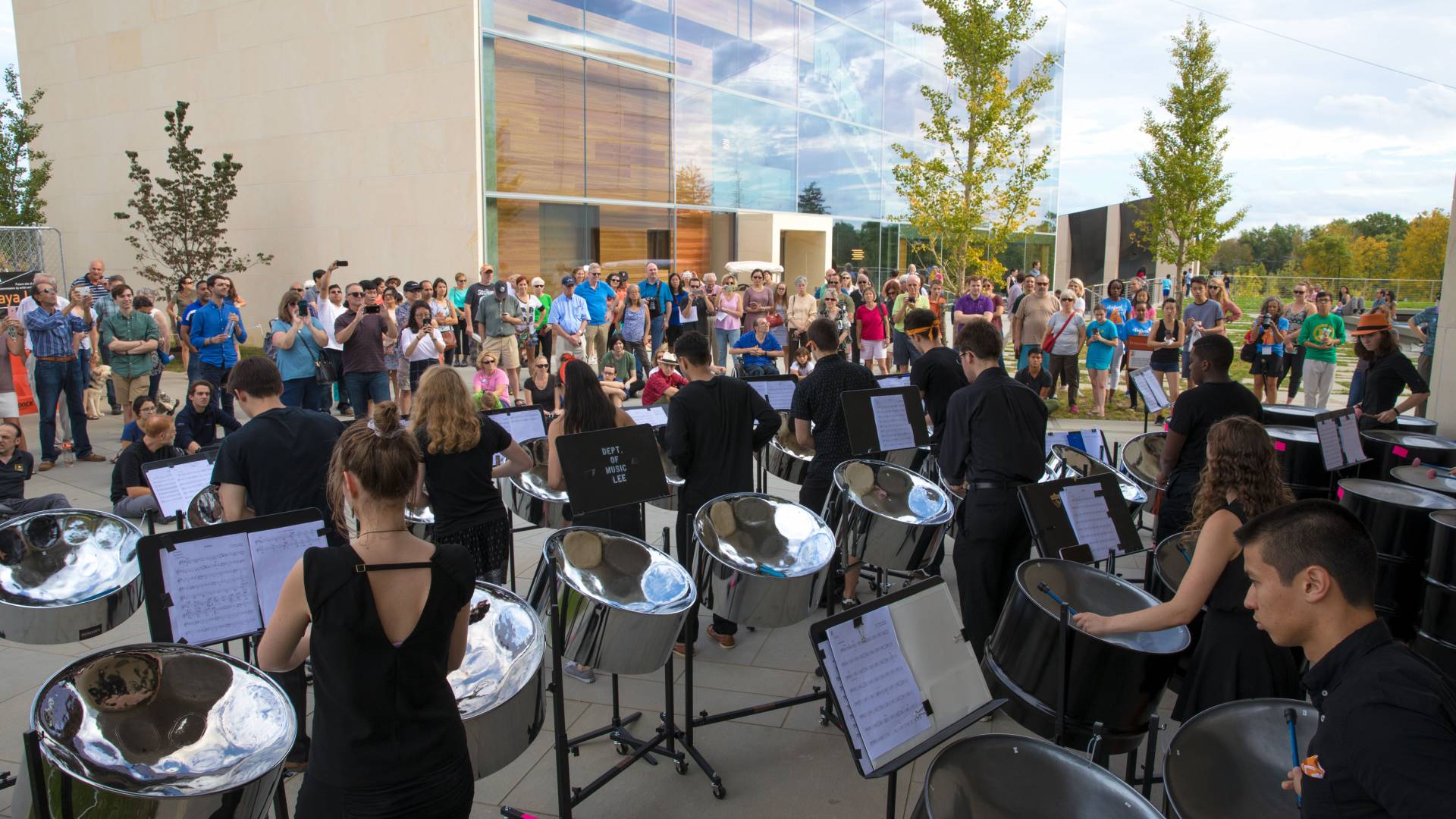 Princeton students playing in steel band to crowd outside Lewis Arts complex