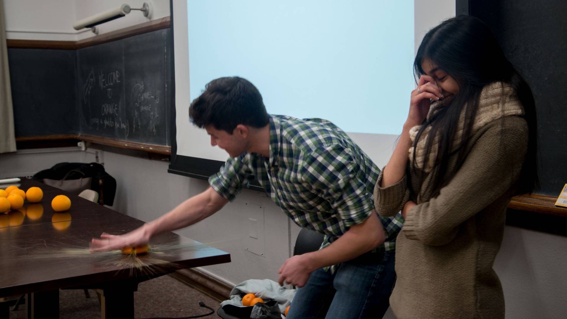 Student smashing orange