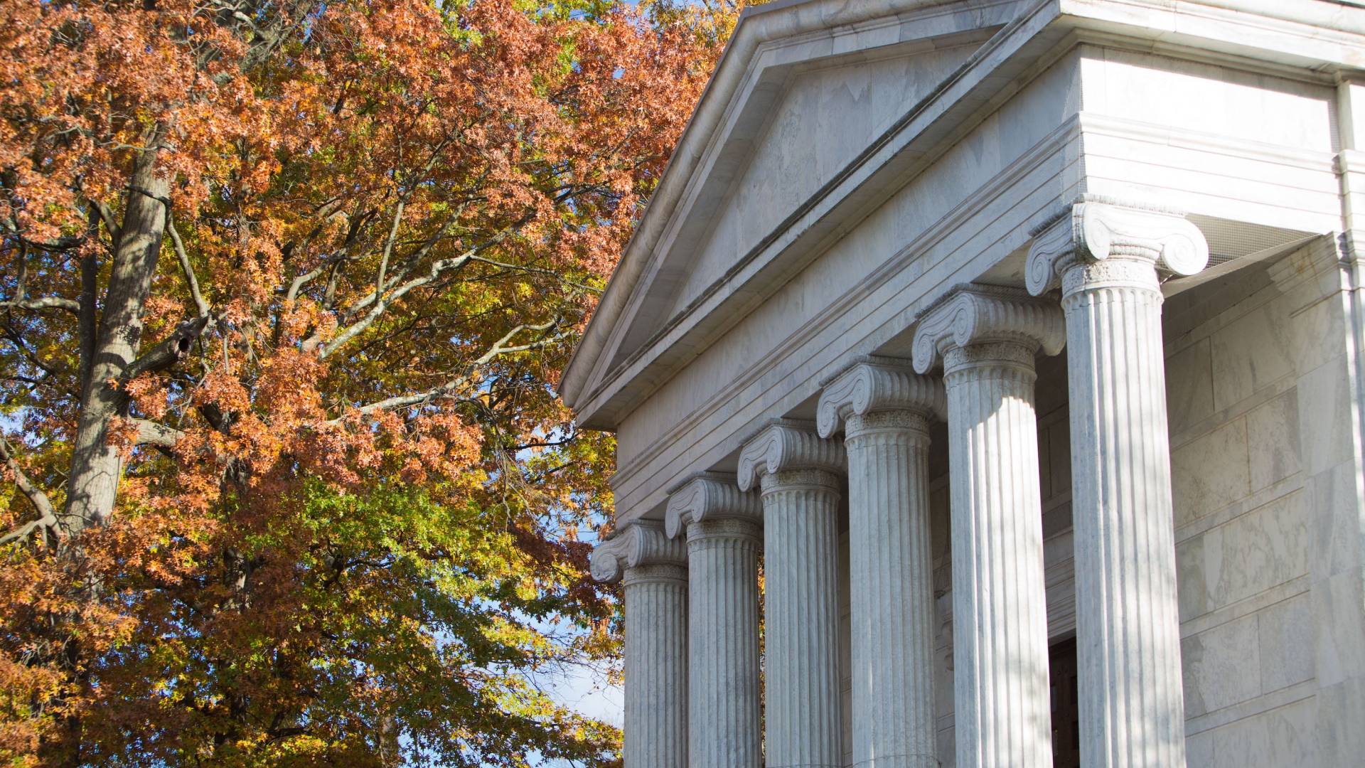 The columns of Whig Hall with autumn leaves in the background