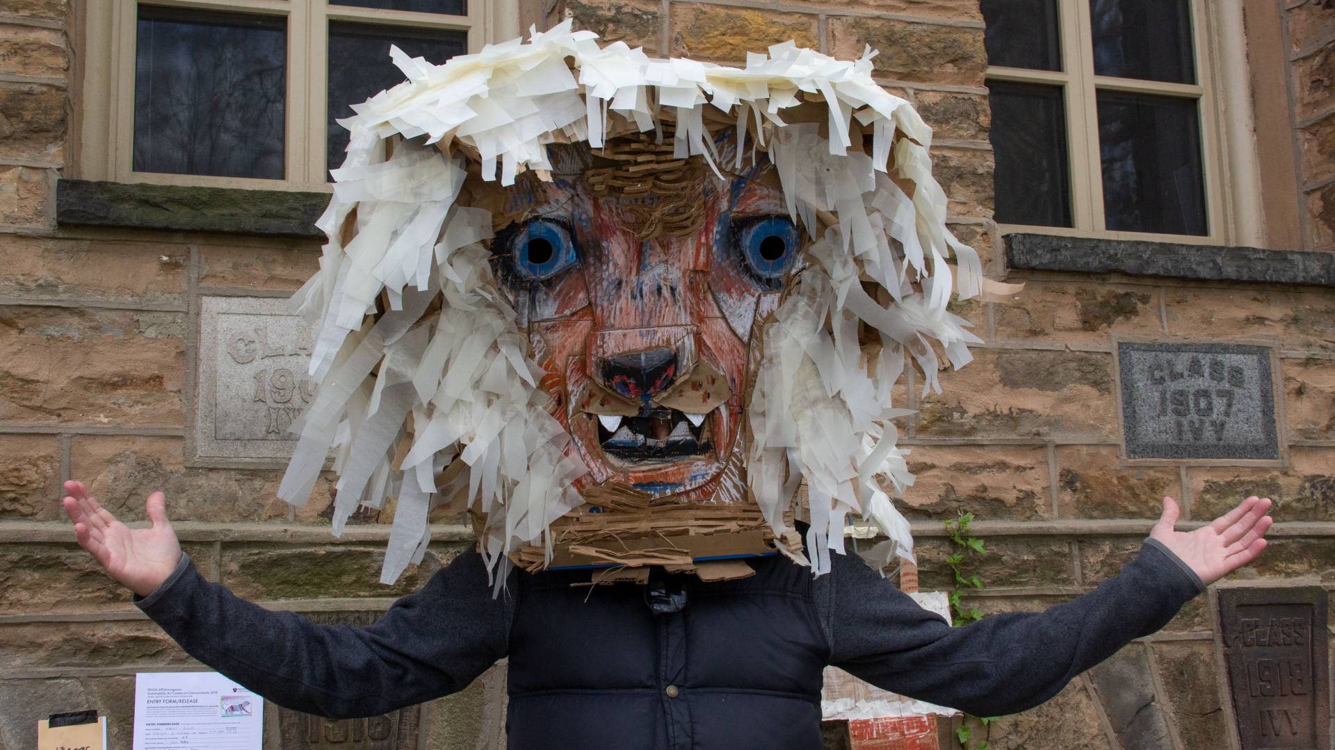 Andres Duque wearing lion mask during trash art contest