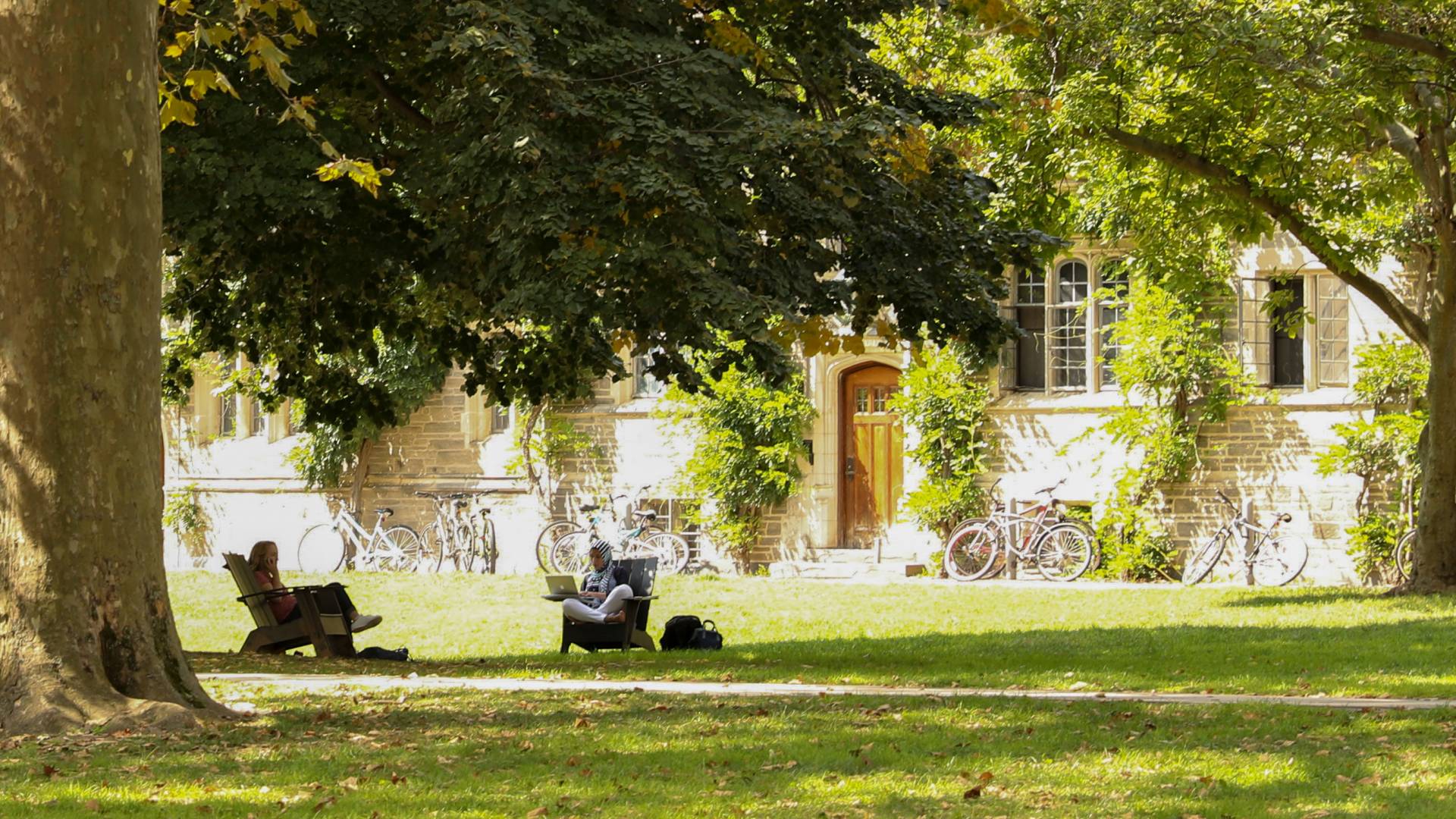 Students sitting outside of campus dorms