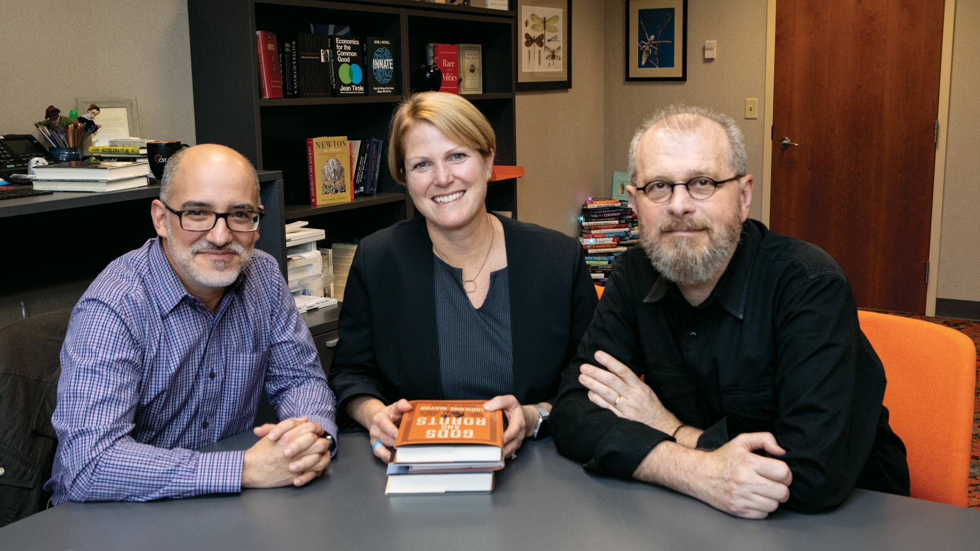 Fernando Acosta-Rodríguez, Christie Henry, and João Biehl sitting at a table
