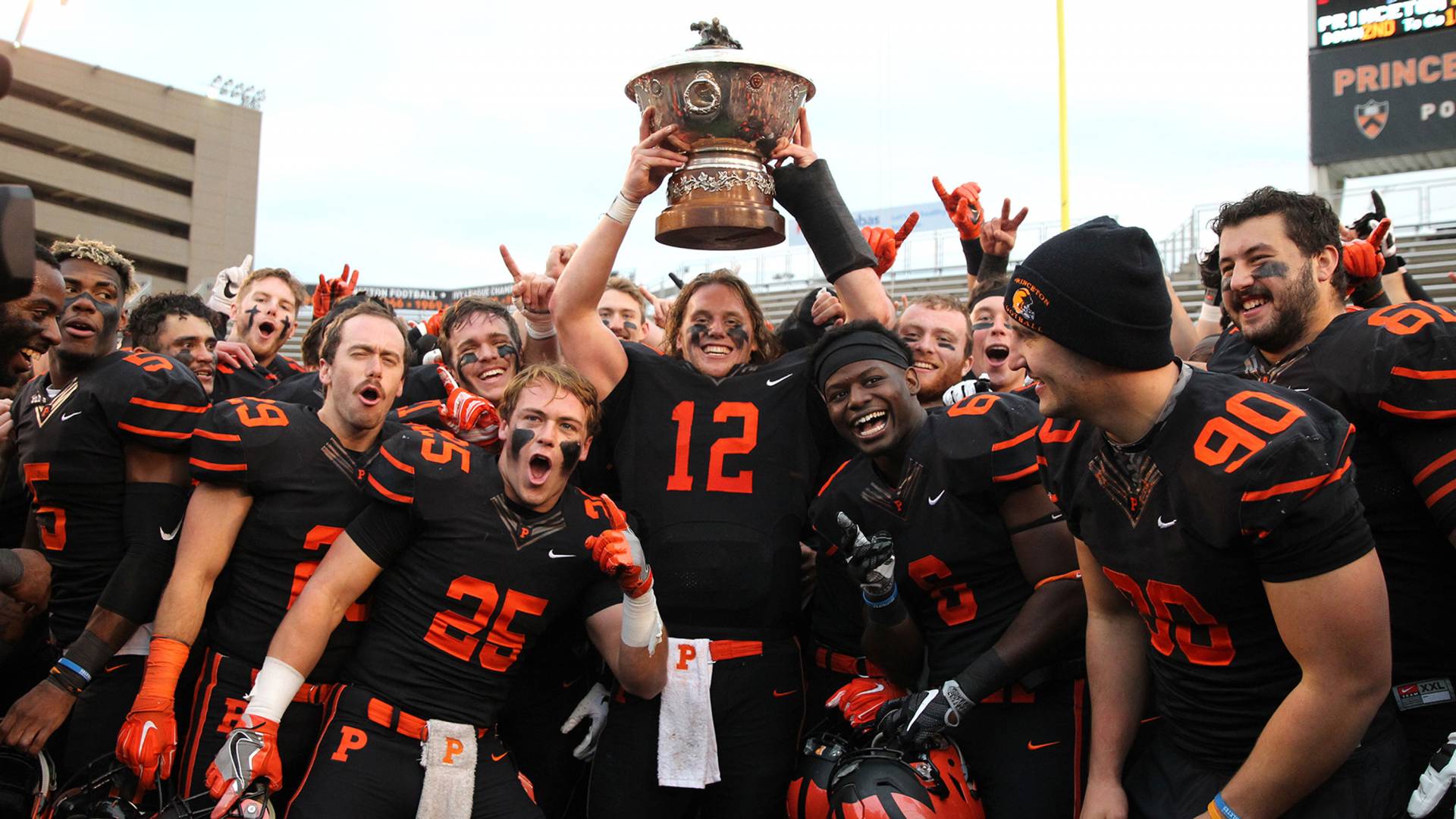 Football team celebrating and holding trophy