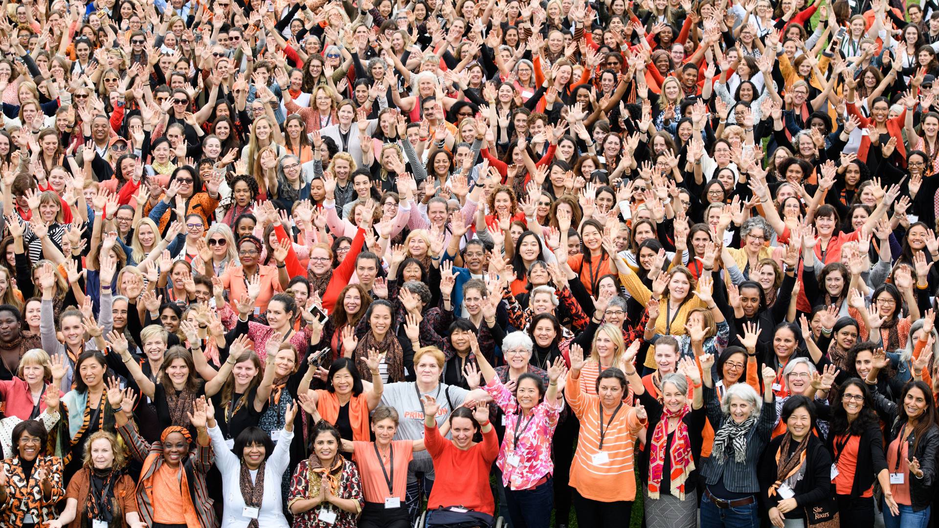 Crowd of women waving up to photographer taking their picture