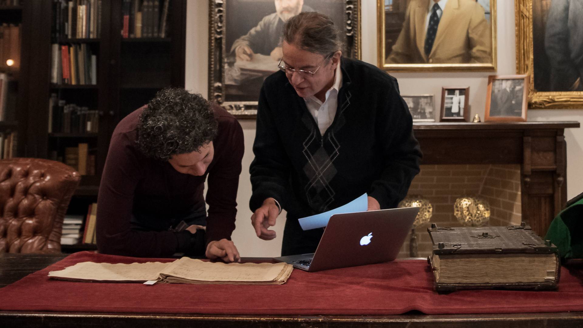Gustavo Dudamel and Scott Burnham looking down at score
