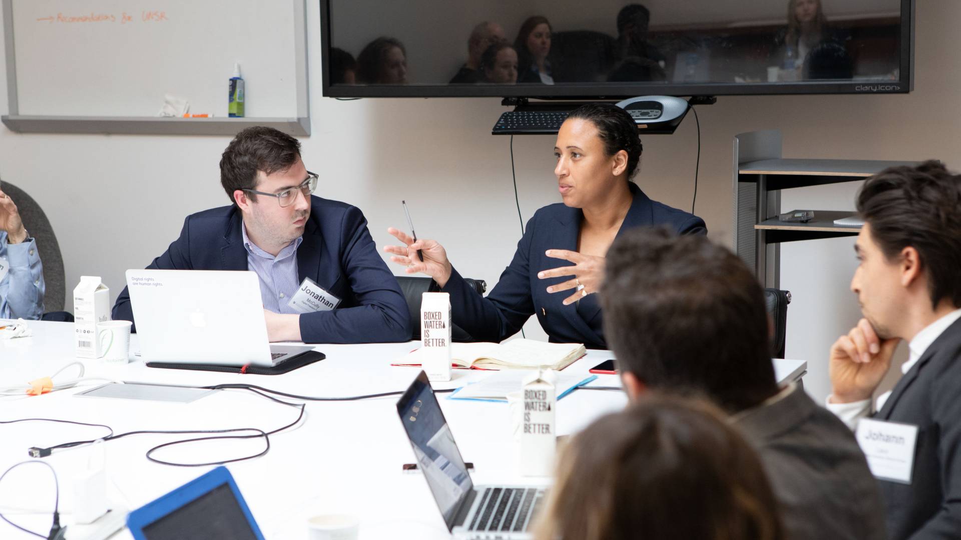 Participants speaking with each other at a table