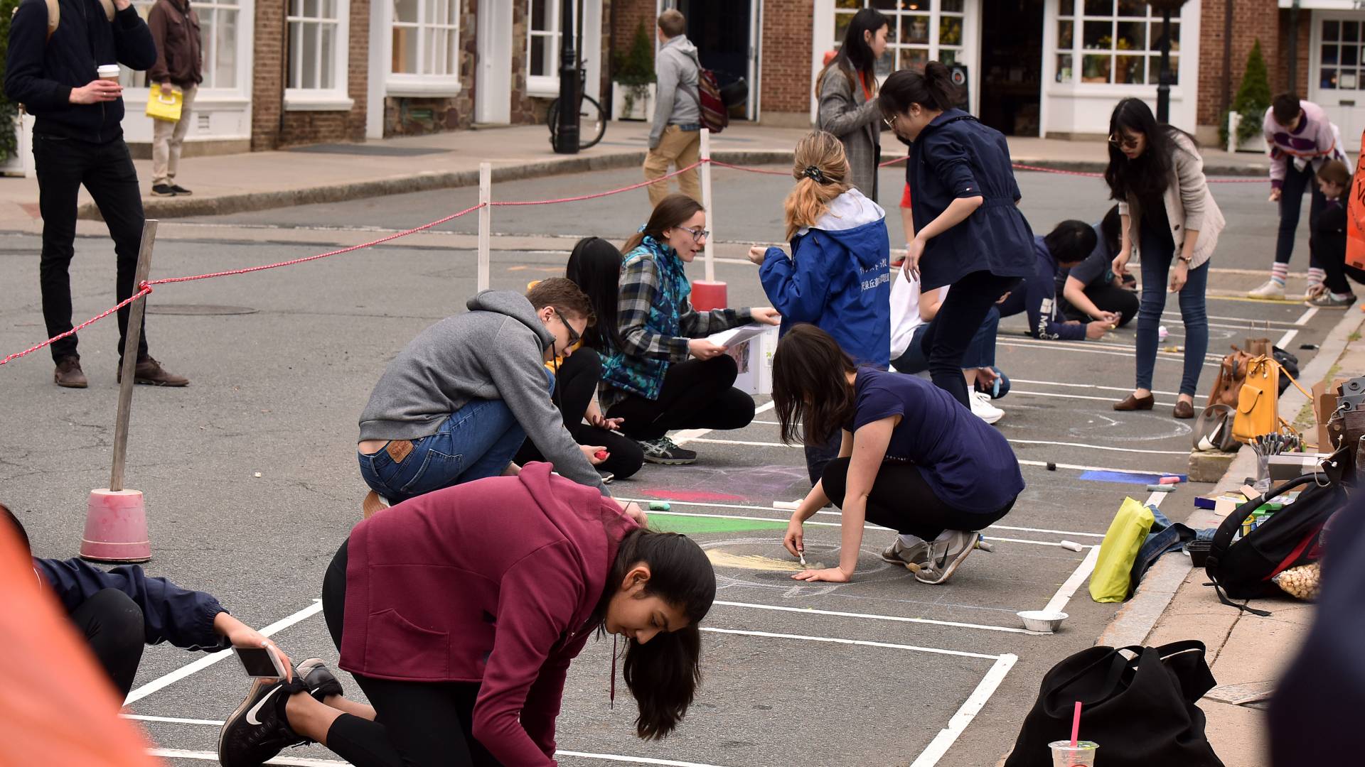 People chalk painting on the street