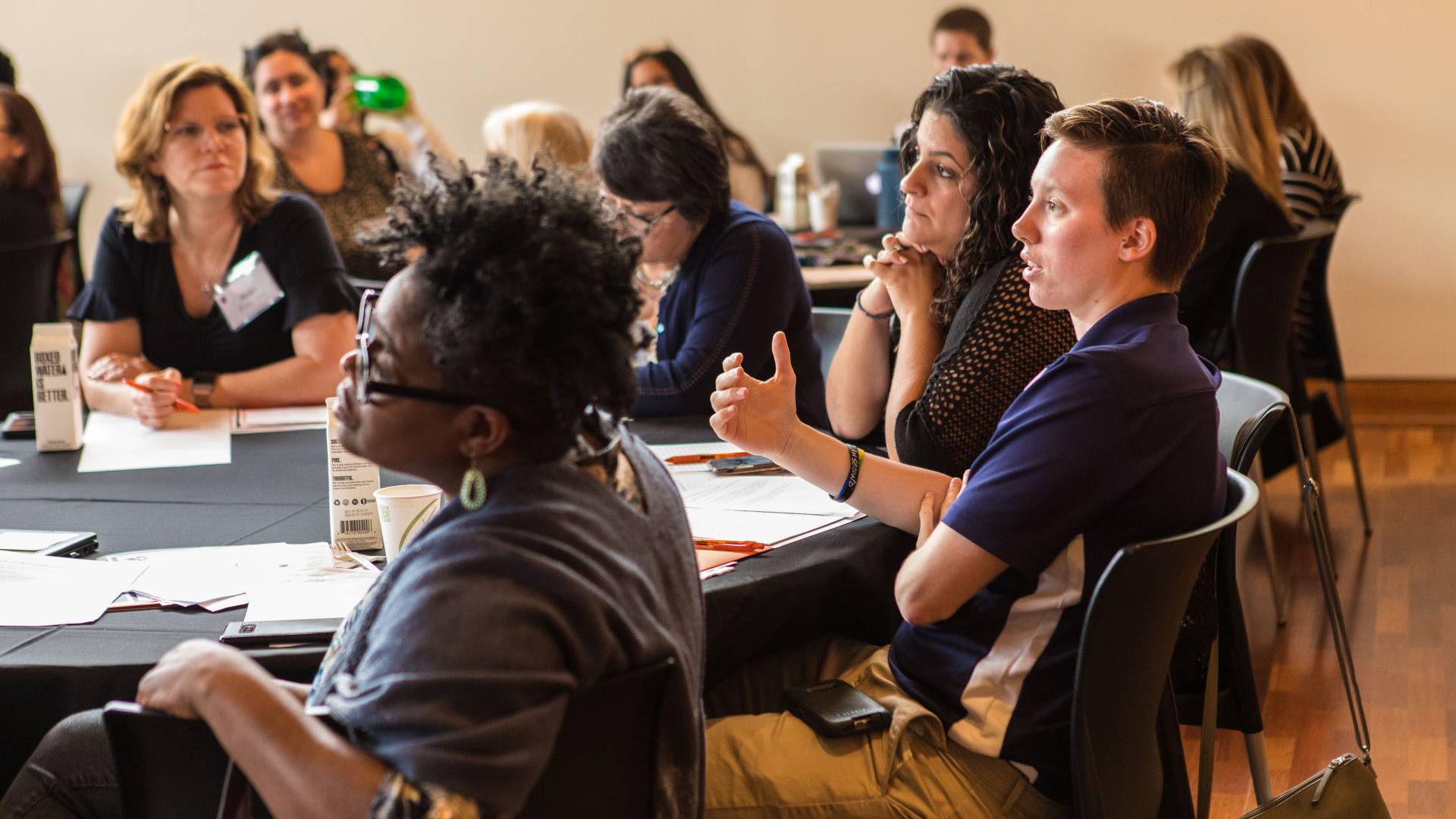 A group at a table speaking during the seminar