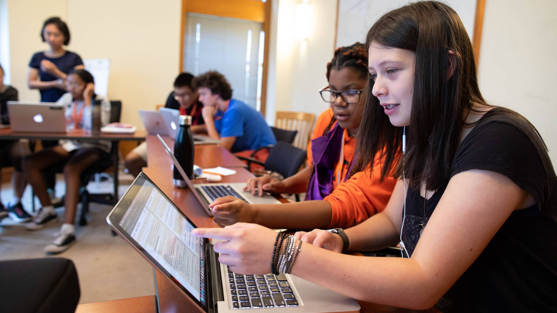 Students pointing things out on laptop screen