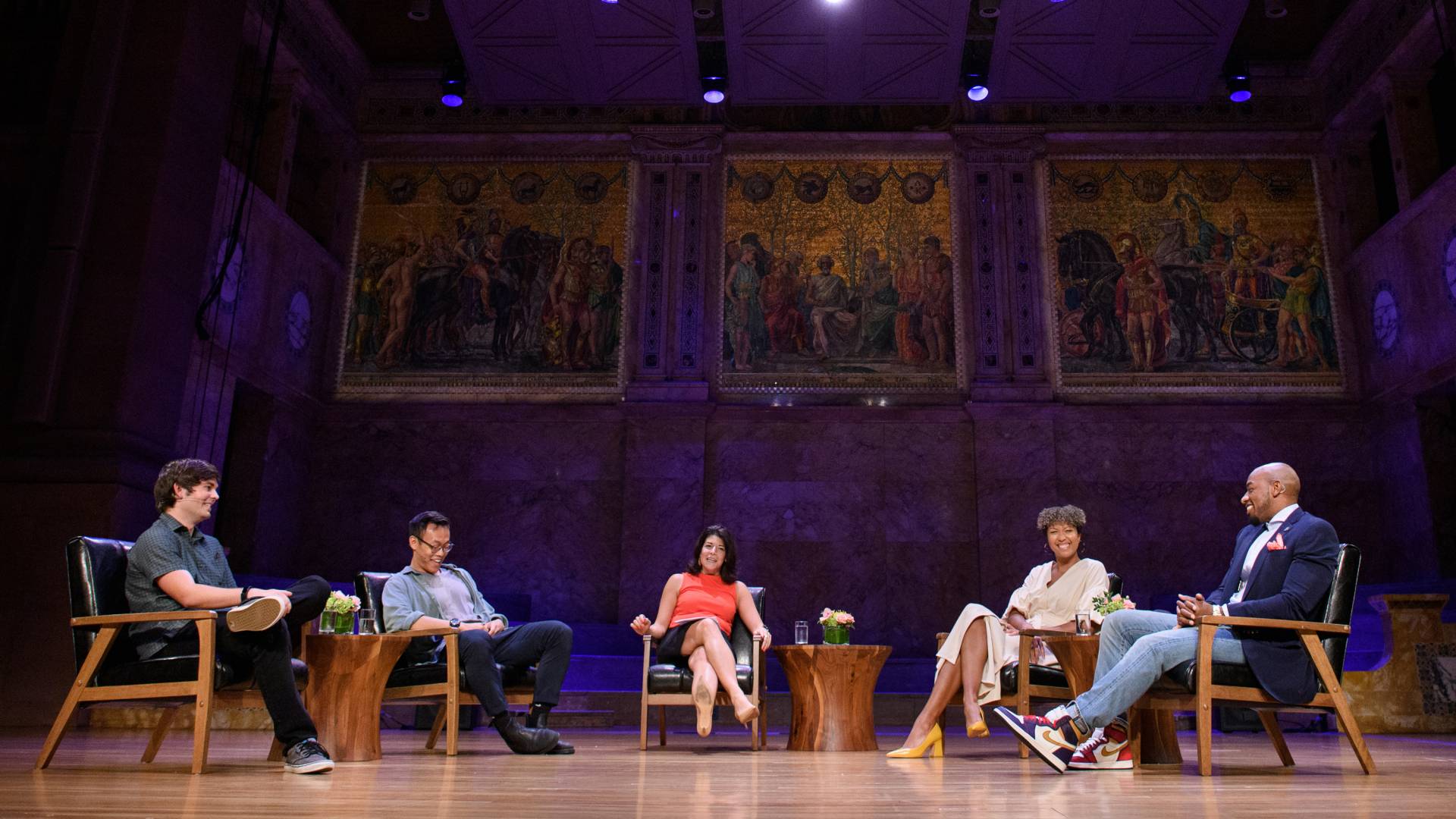 Panelists sitting on stage talking