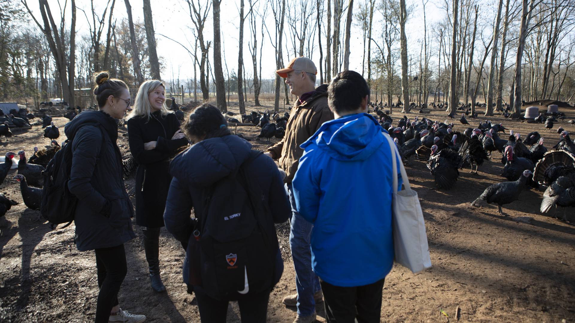 Carruth and the farmer laugh as the 3 students prepare to record their interview