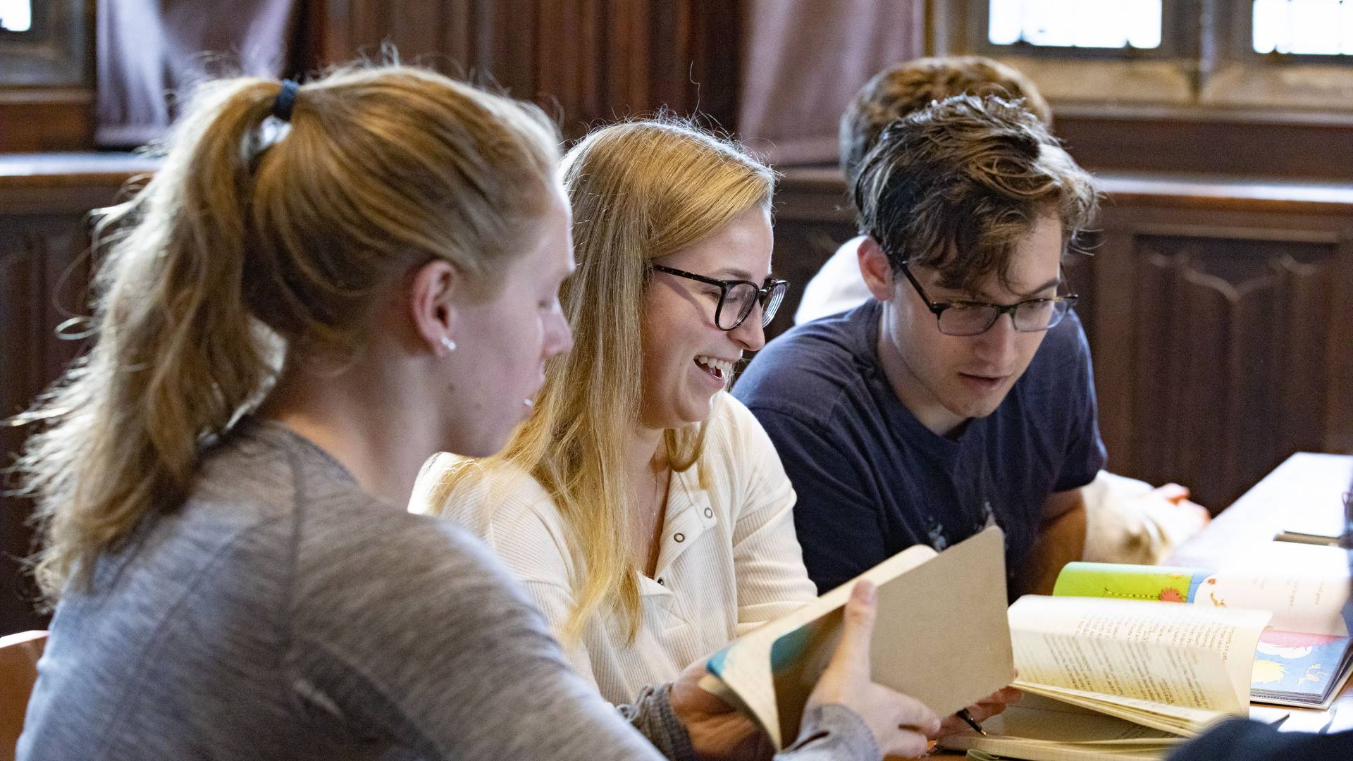 Students discuss the work in groups