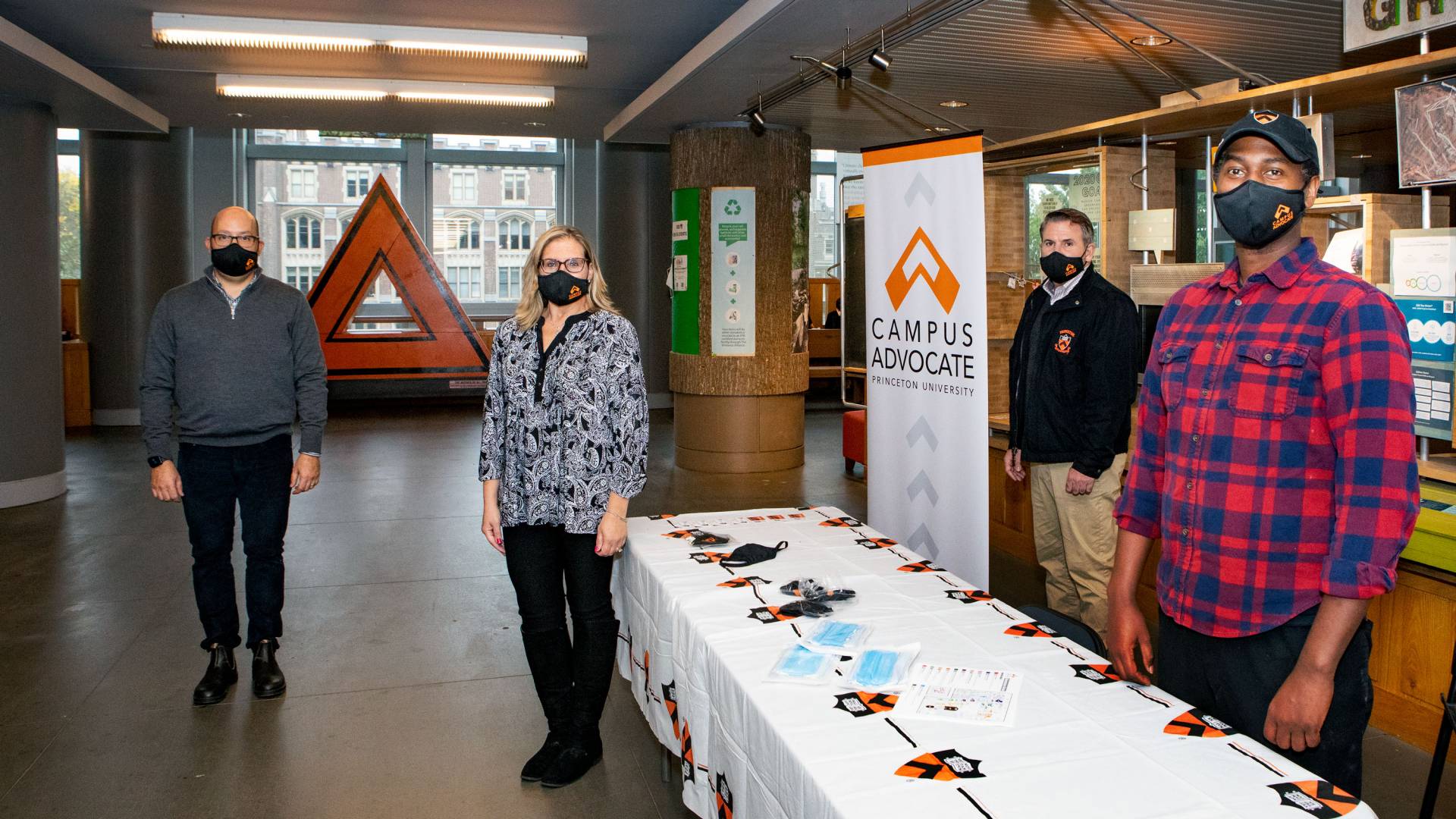 Organizers stand near the information table at Frist
