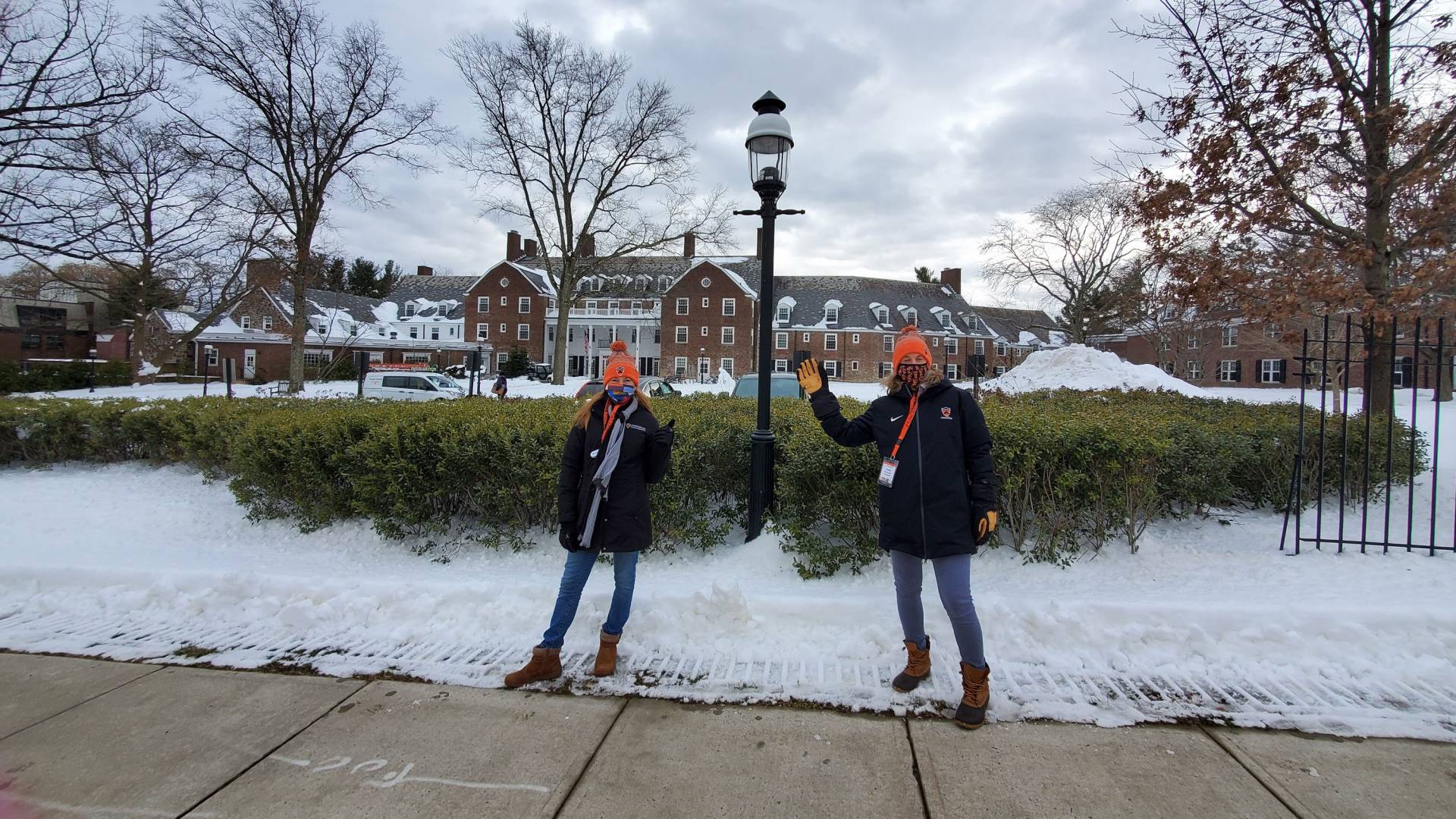 Community Advocates standing on sidewalk in front of Forbes College. 