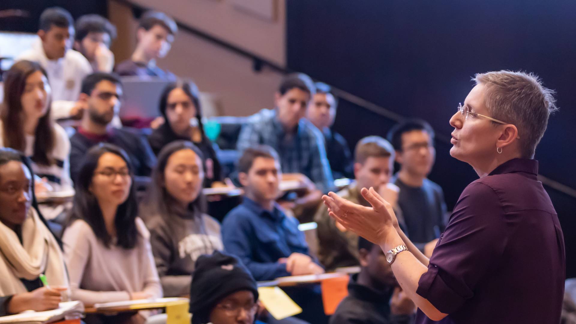 Faculty member addressing students in tiered lecture hall