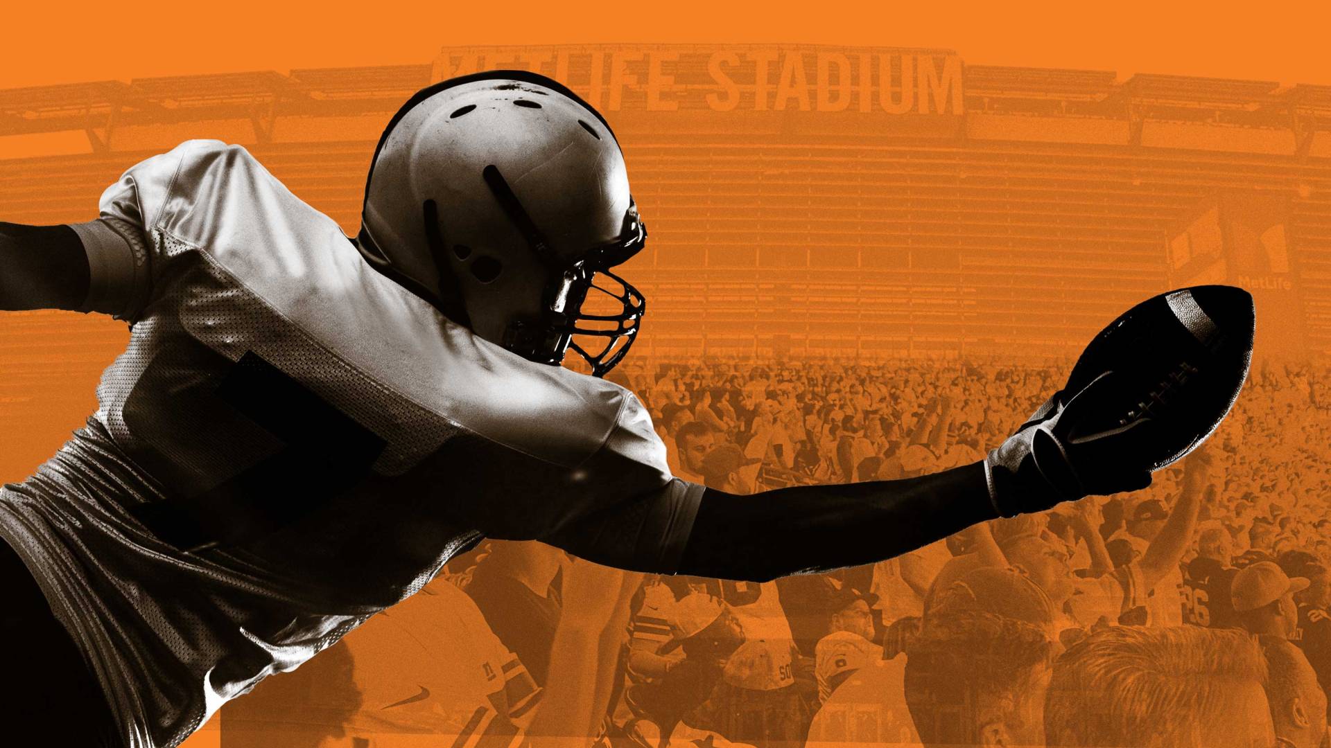 a football player lunges to catch the ball