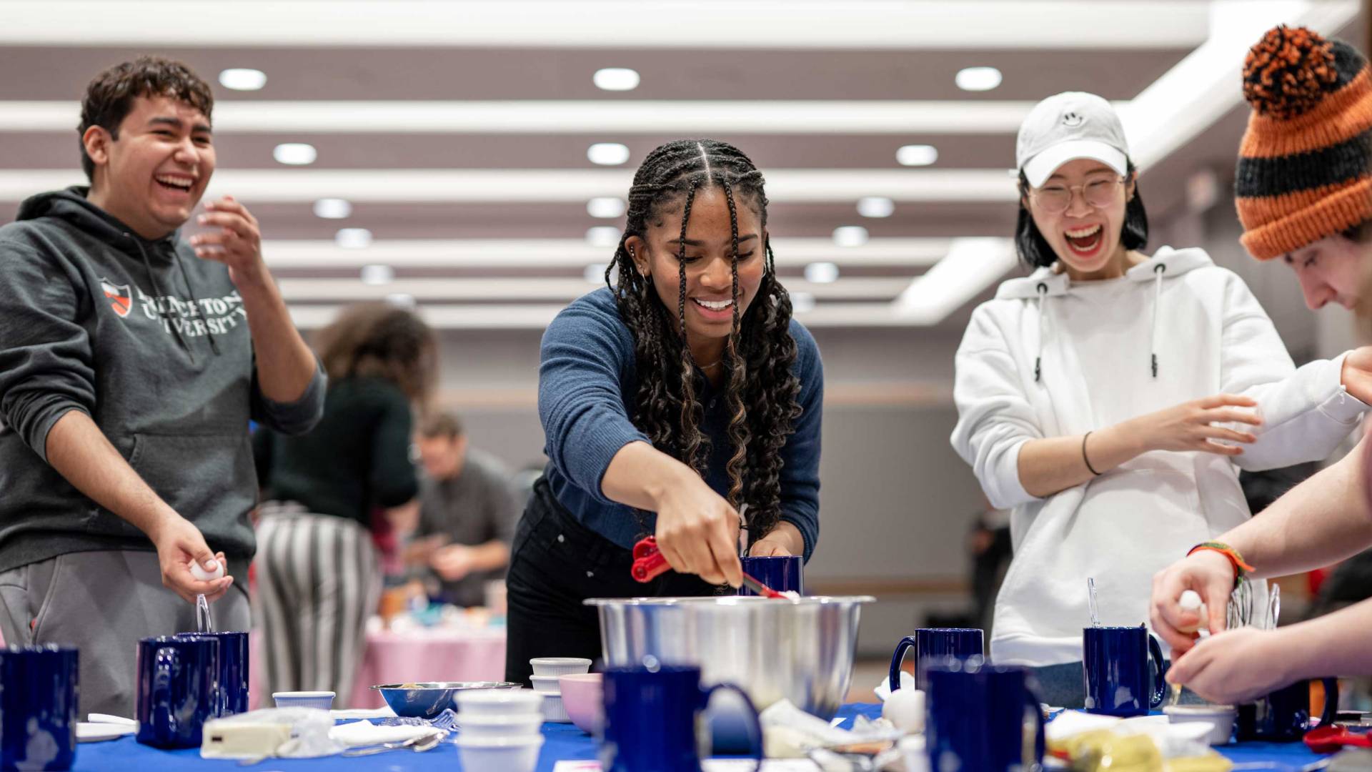 Students laugh as they participate in a TikTok cooking lesson