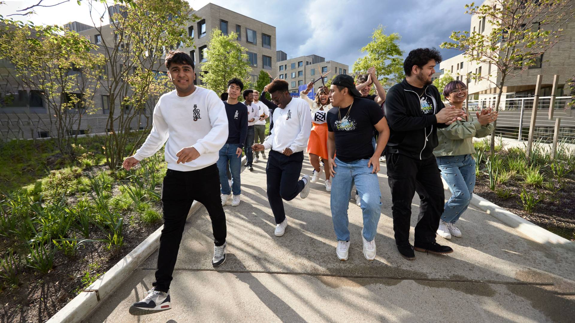 Students and Kwanza Jones dance to dedication ceremony