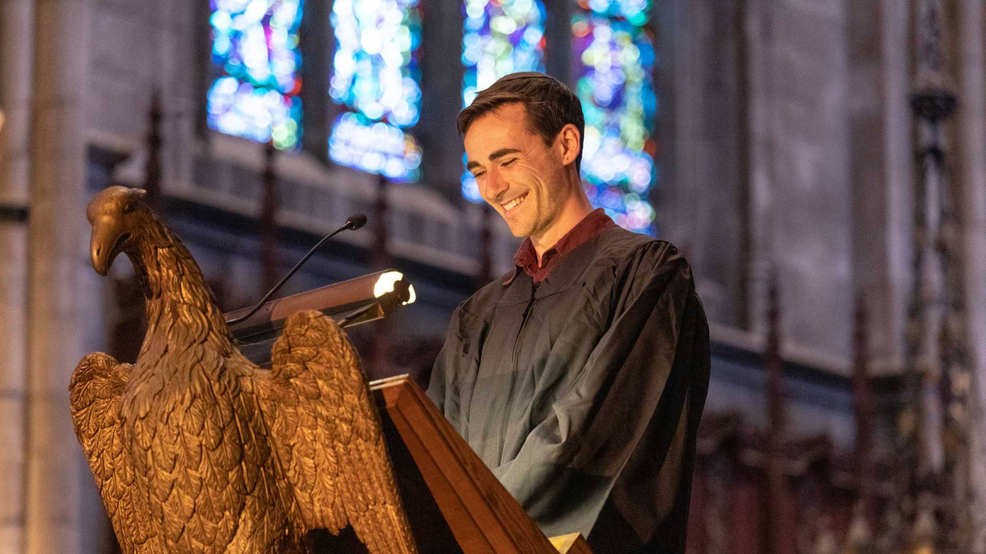 A student reads at Baccalaureate service
