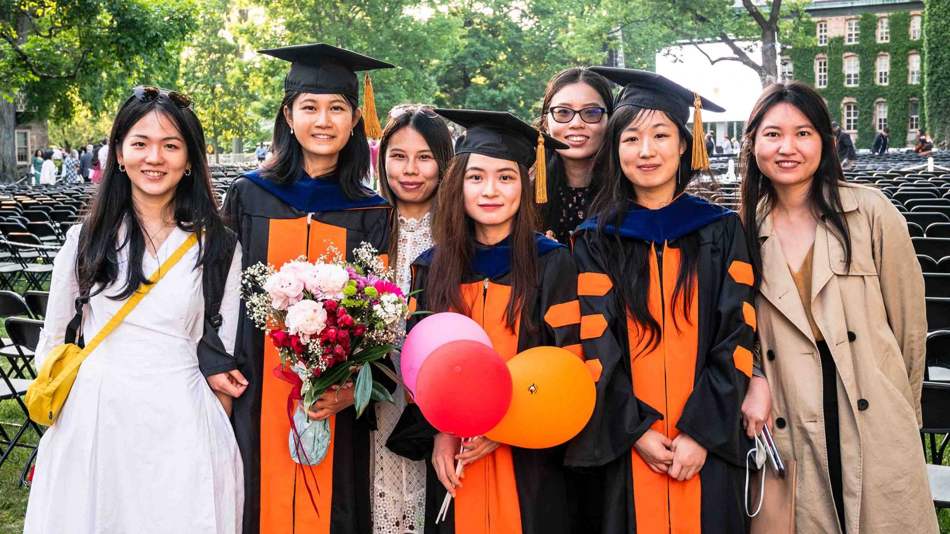 Graduating students smiling as a group.