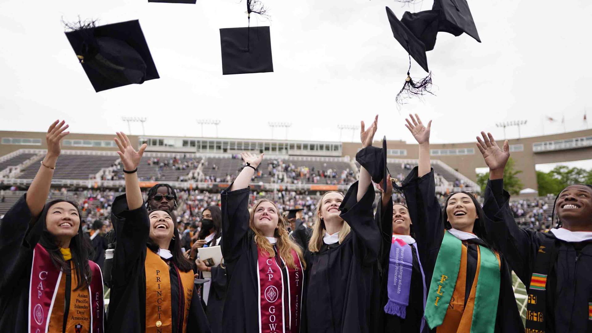 Graduates throwing their caps up in the air