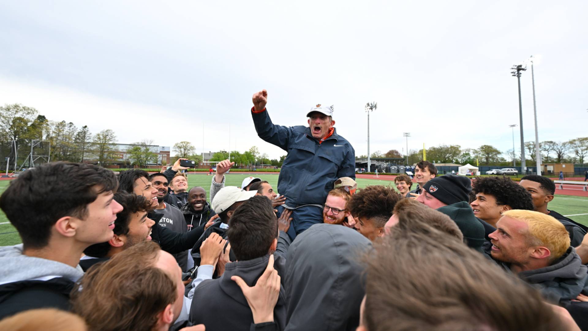 Fred Samara being carried by student athletes
