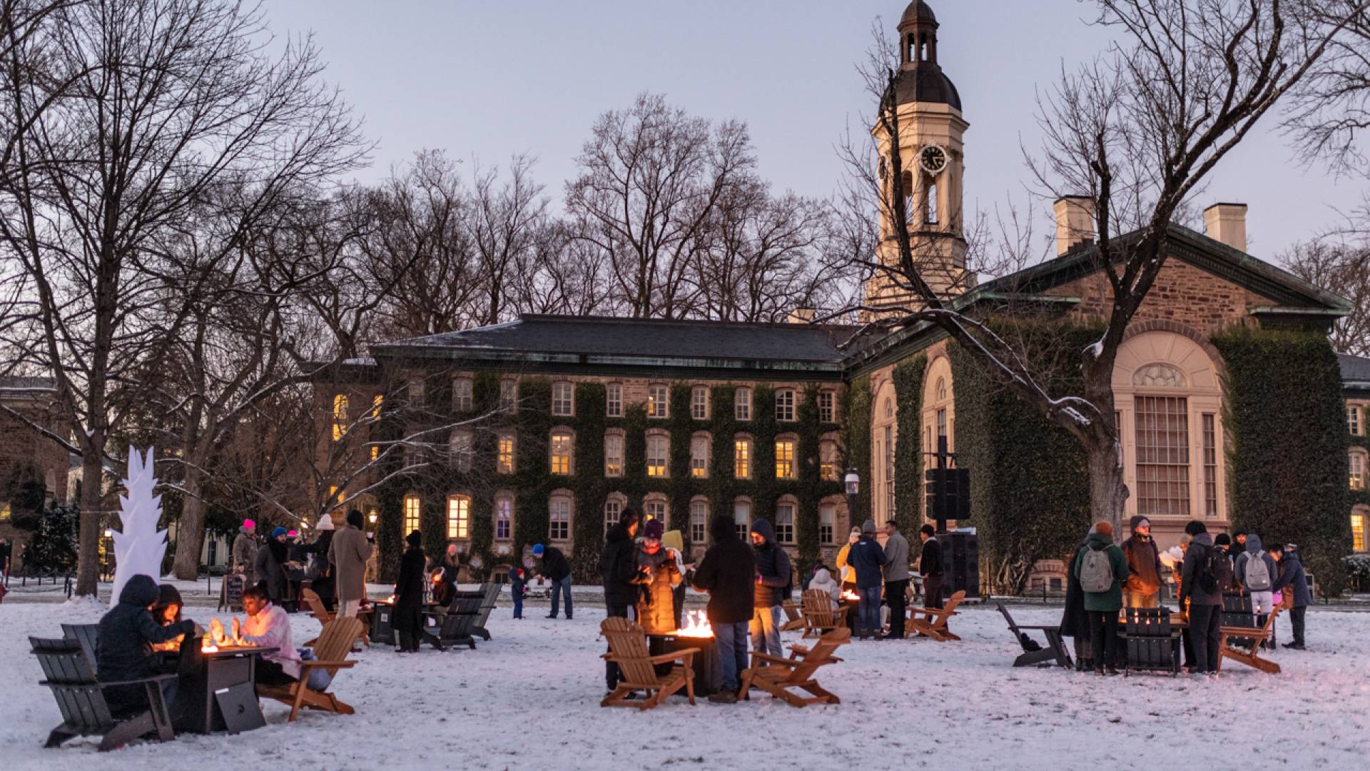 Students stay warm thanks to campfires set up on Cannon Green as part of the Wintersession Kick-off Festival.&nbsp;