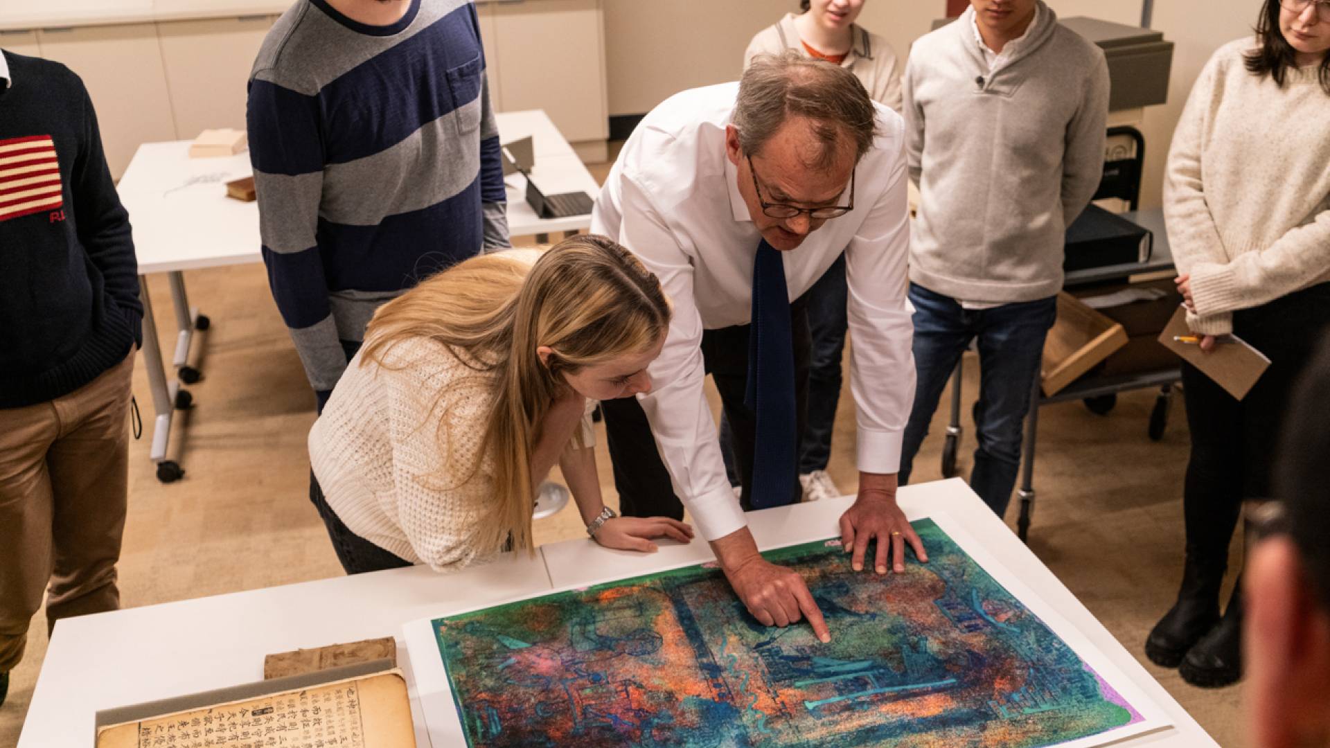 William Noel (right), the John T. Maltsberger III ’55 Associate University Librarian for Special Collections, shows undergraduate and graduate students a detail from a medieval manuscript housed at Princeton University Library's Department of Special Collections.&nbsp;