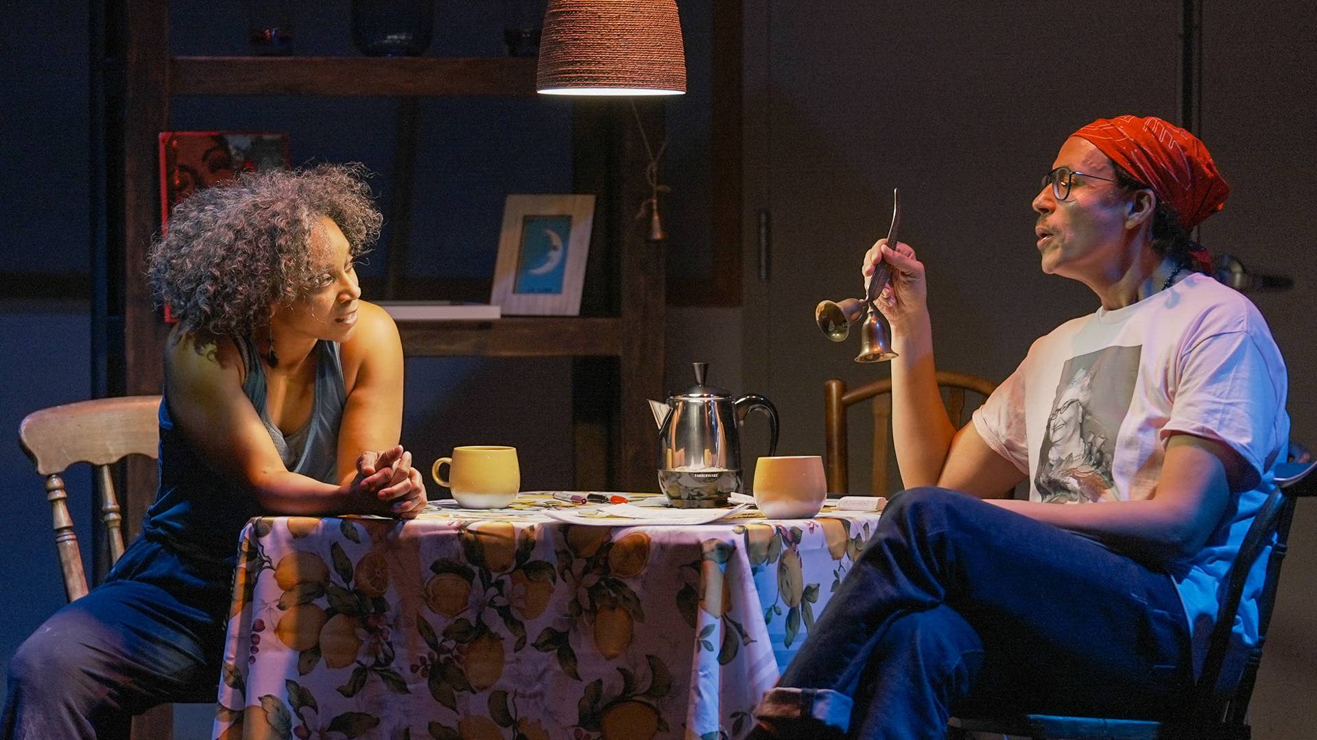 Two individuals sitting around a table in conversation.