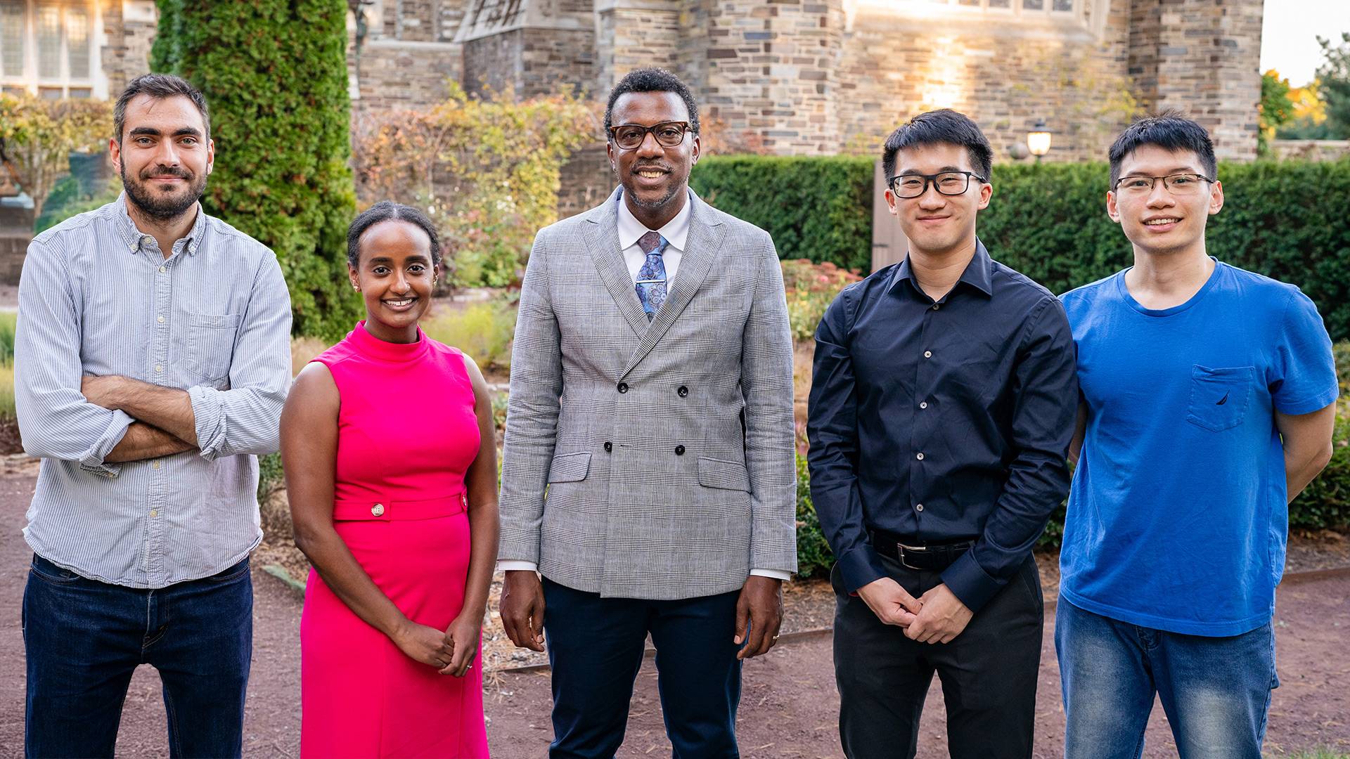 The four Jacobus Fellows of 2025 standing together in front of a garden