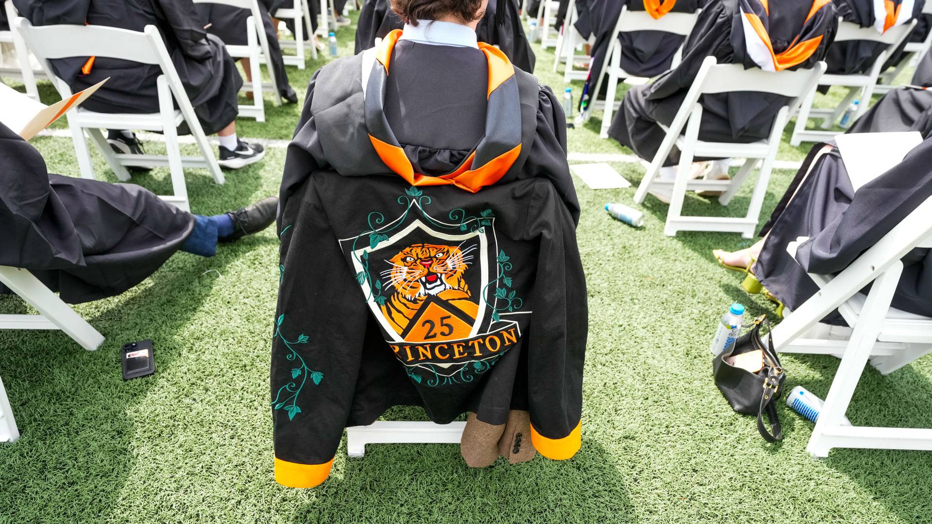 The back of a graduate's seat shows their class jacket 