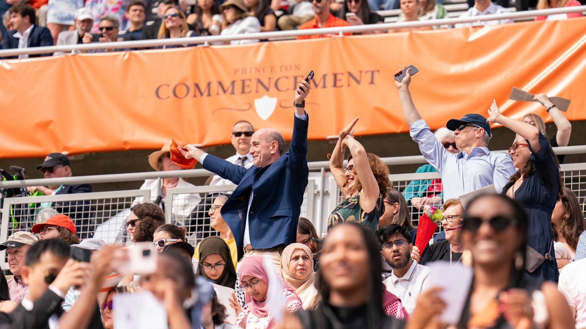 Commencement attendees wave to graduates 