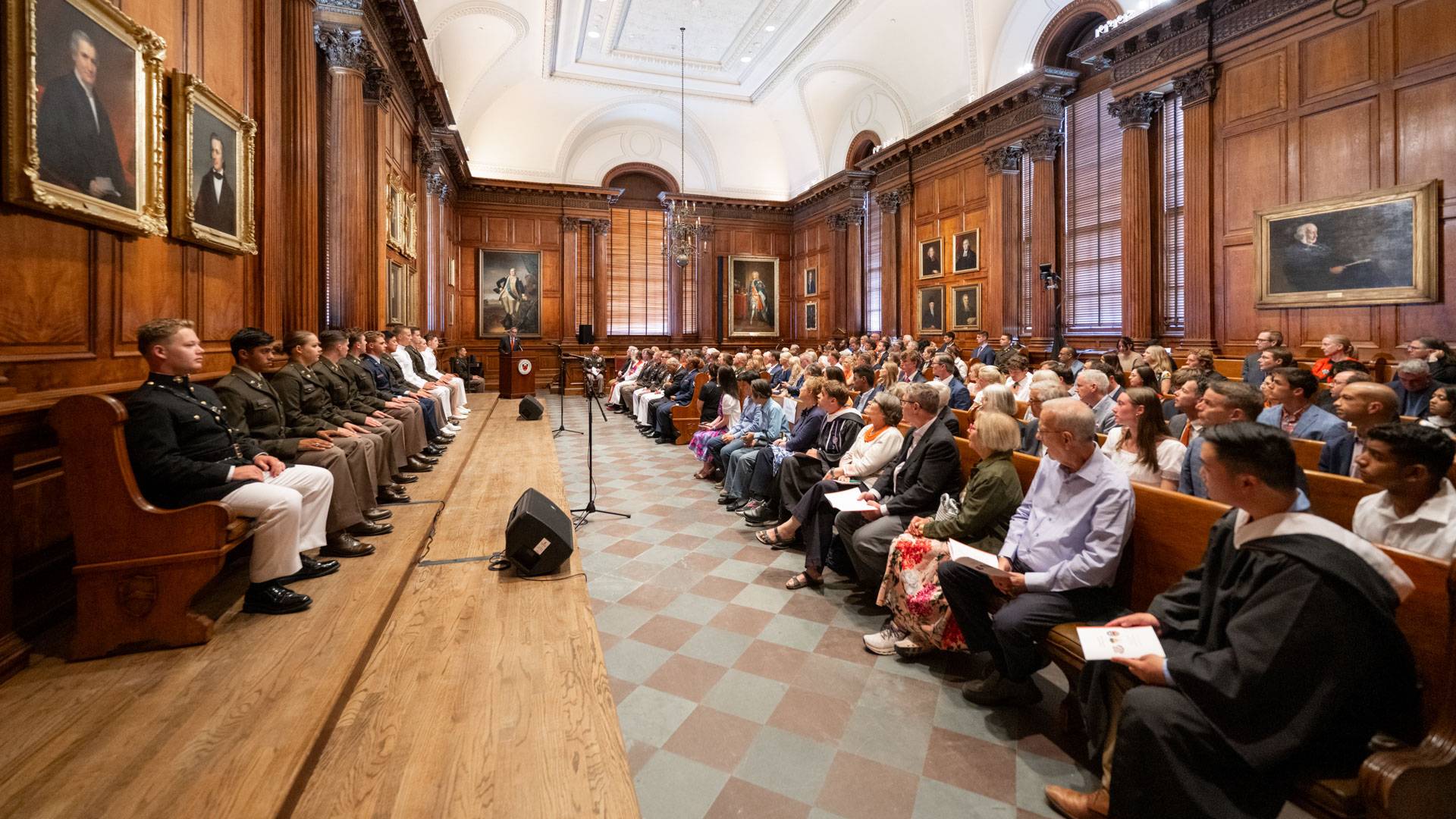 Attendees fill the pews of the Faculty Room in Nassau Hall as Princeton University President Christopher L. Eisgruber delivers his congratulatory remarks.