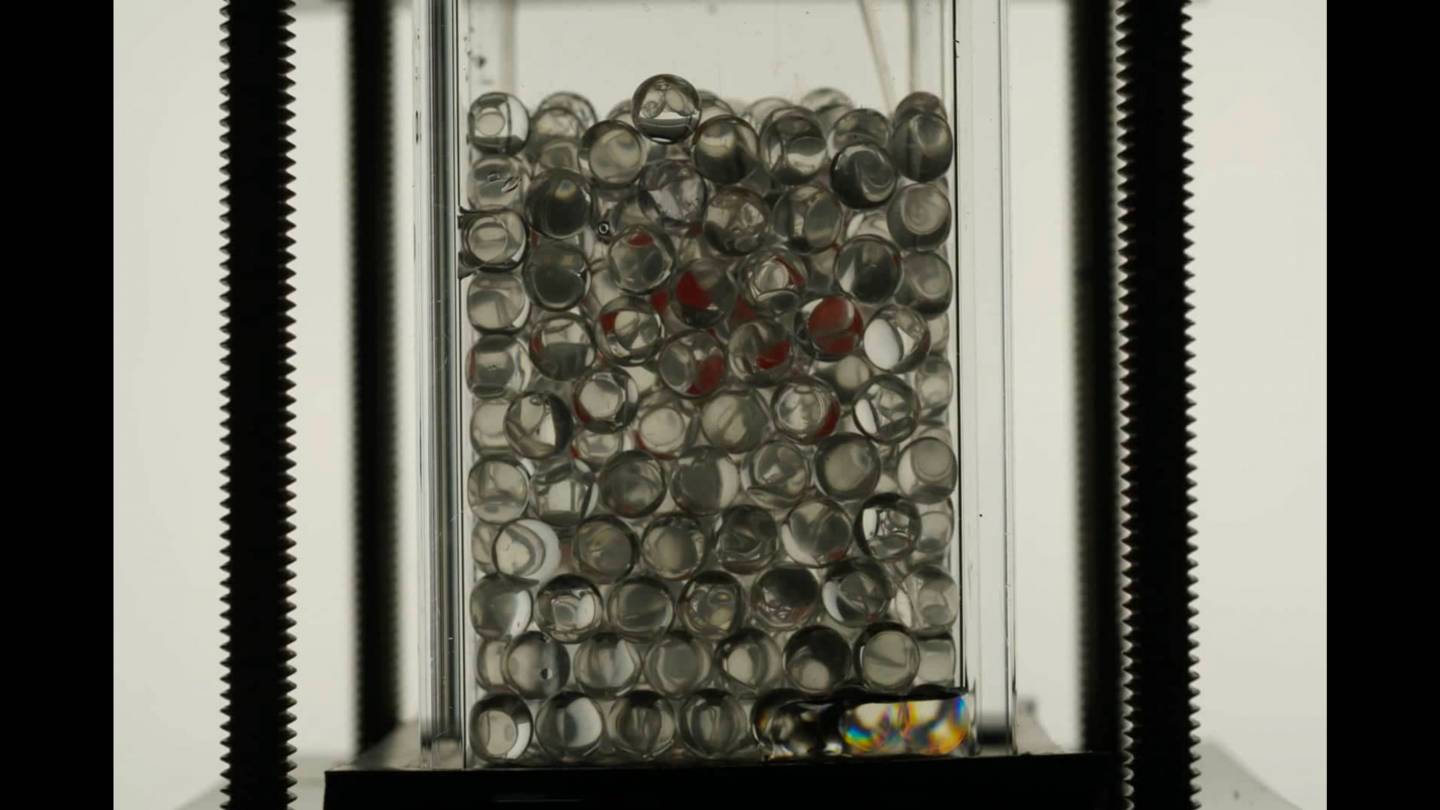 a container of beads fills up with liquid