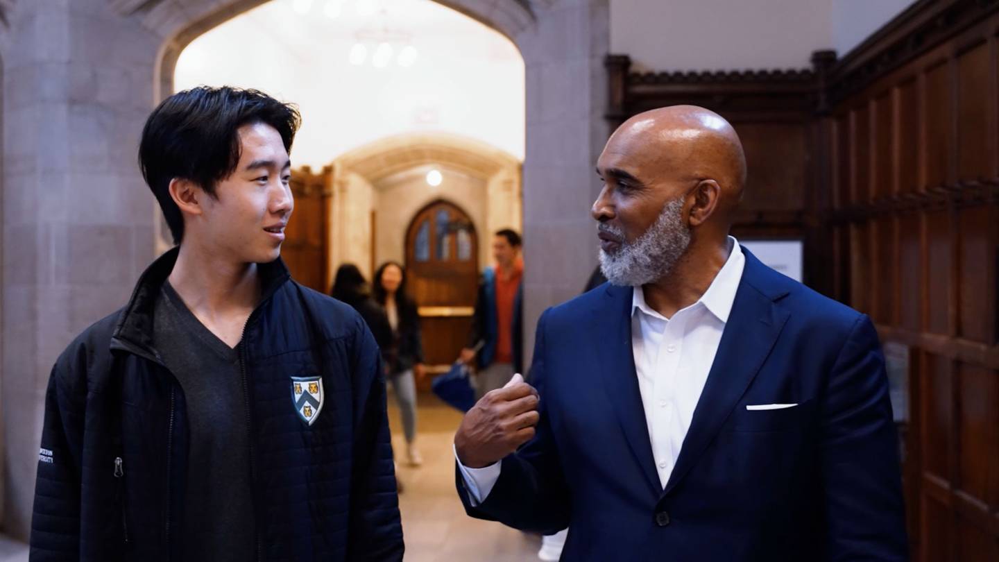 Two people walk through the halls of a university building as an introduction to a video about Princeton's diverse suppliers of goods and services