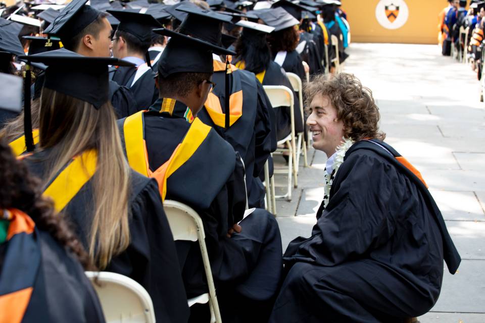 Kyle Berlin talking to graduate during Commencement ceremony