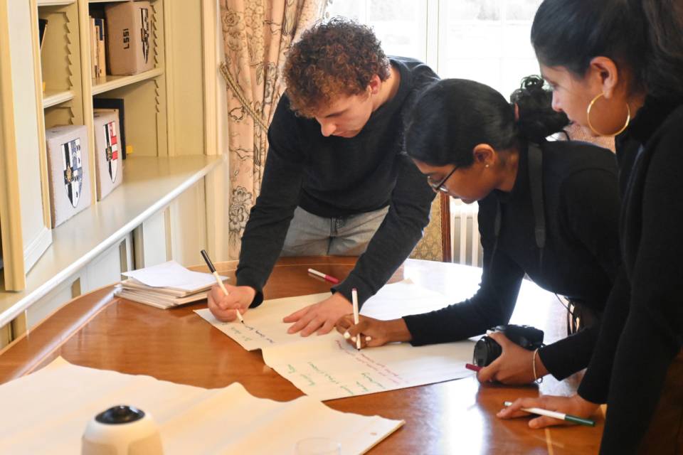Group of students writing on paper.