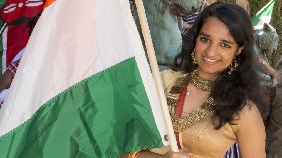 A student waves a flag proudly at the 2016 Communiversity event
