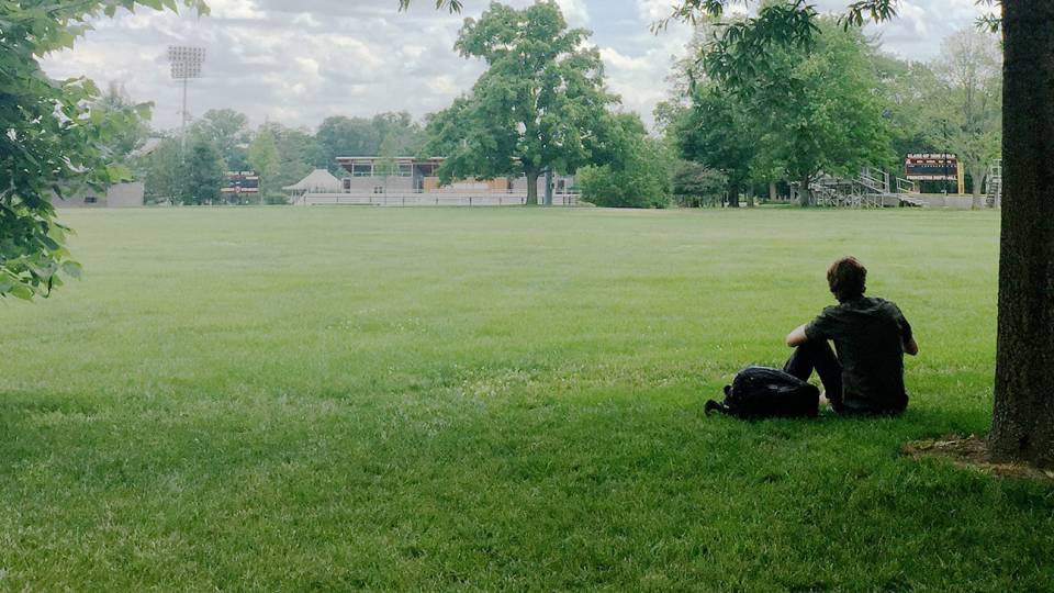 Student with backpack in Poe Field