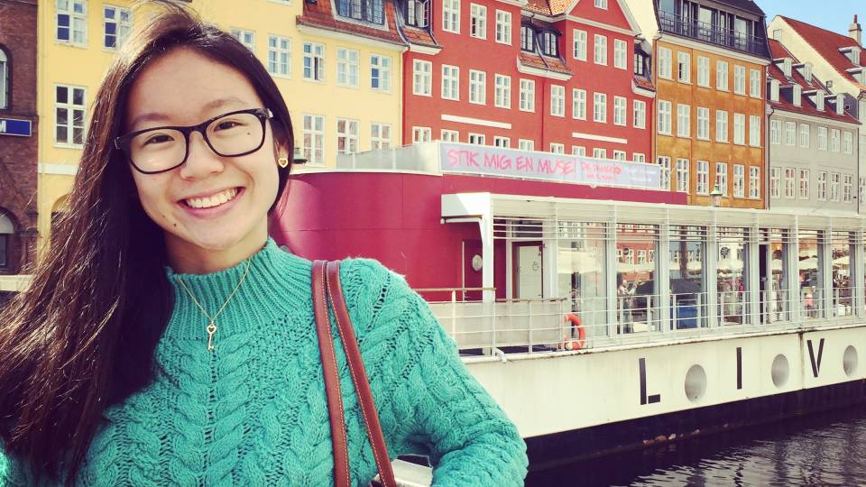 Portrait of Jin Yun Chow posting on a bridge.