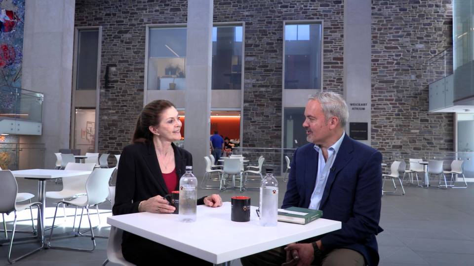 Sandra Bermann and Stephen Macedo talk at a table