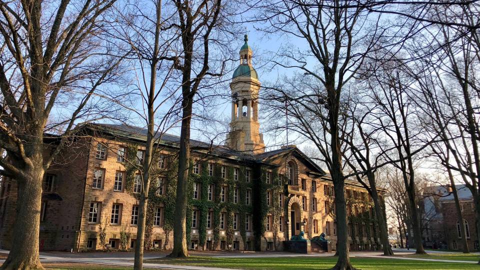 Nassau Hall in the evening sunlight on a spring day.