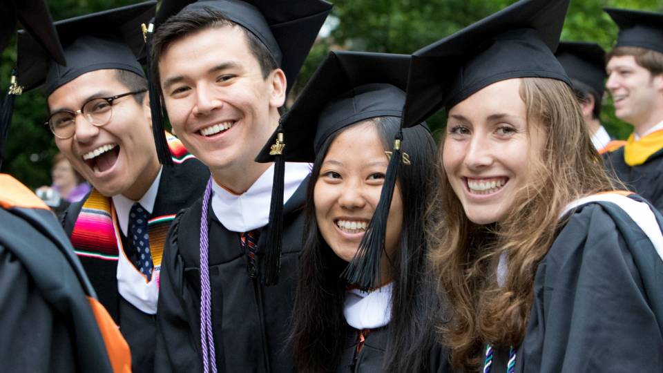 Students smiling at Commencement