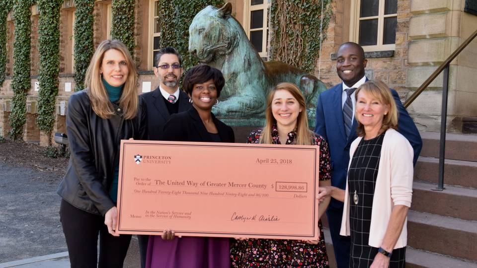 United Way team holding check