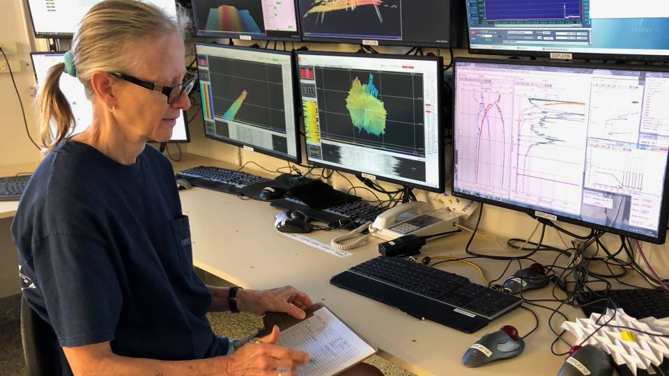 Bess Ward analyzing data on ship