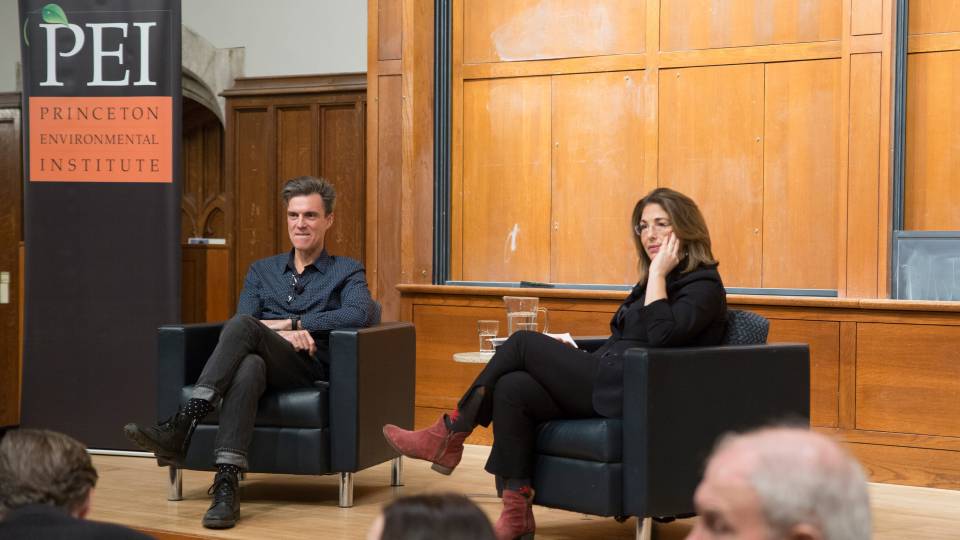 Ashley Dawson and Naomi Klein sit on a stage and speak at an event